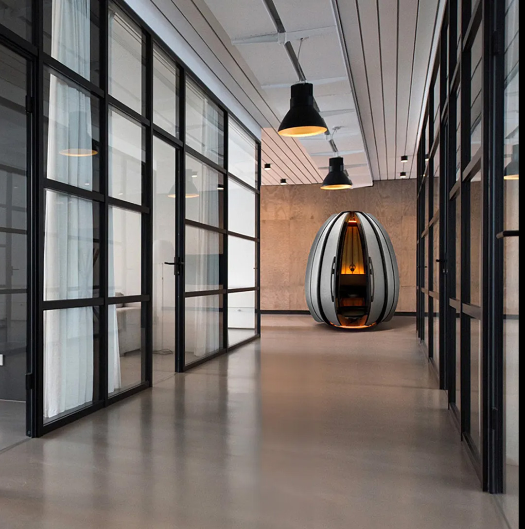 Modern office with glass walls and the OpenSeed Lotus pod at the end of the hallway.