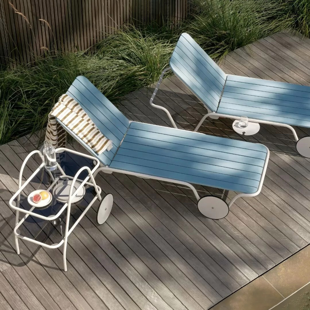 Billy Sunlounge chairs by Tait on wooden deck outdoors in dappled sunlight.