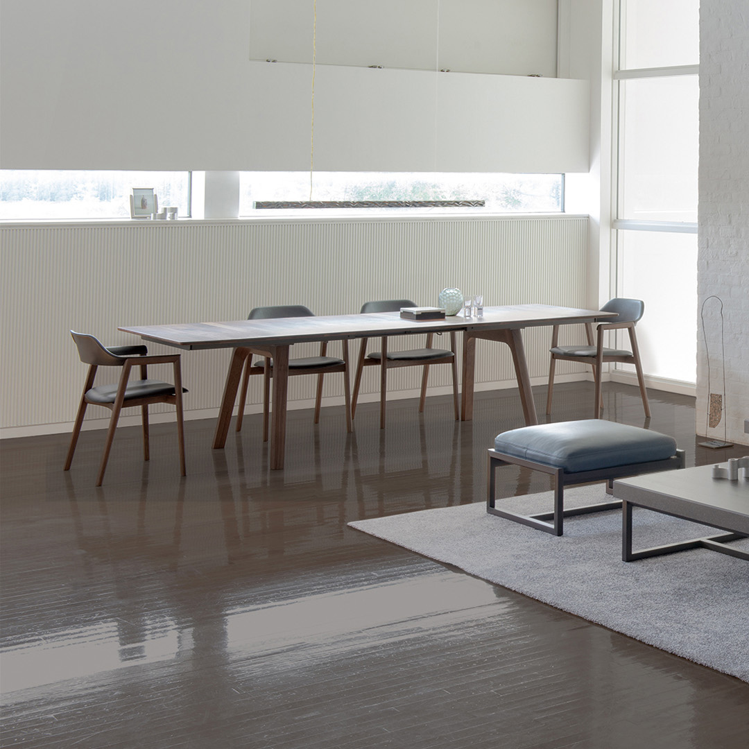 Modern open living room with kitchen and dining area featuring the Ten Table by Conde House.