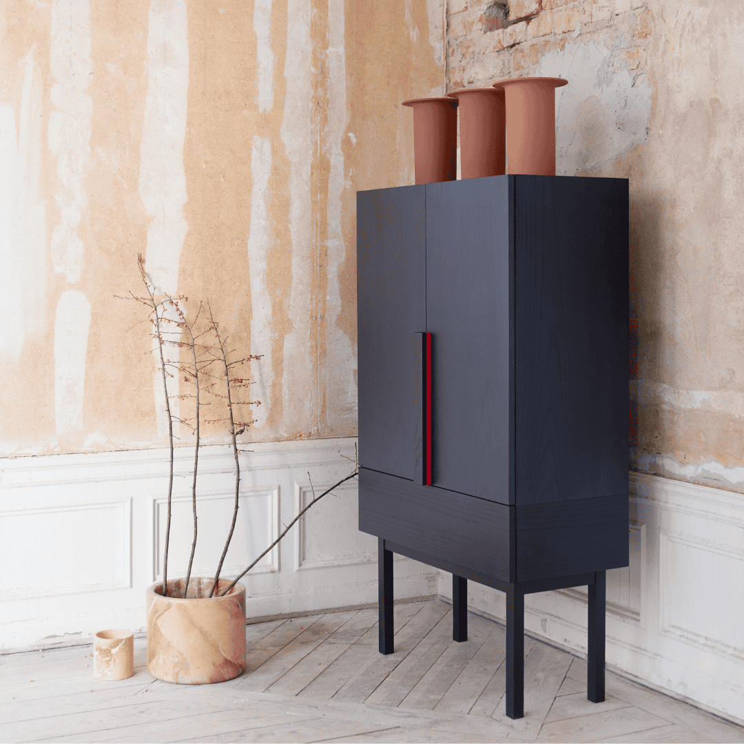 A functional storage piece for compact spaces, featuring a concealed handle, recessed top, and a bold palette inspired by traditional Japanese finishes such as sumi ink, red dye, and Aizome indigo.